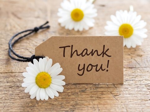 Brown craft tag with thank you message surrounded by daisies