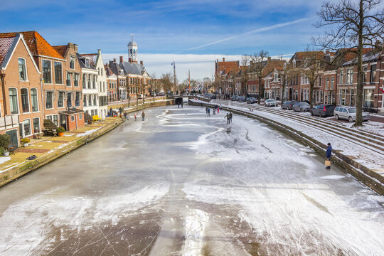People on the ice of the central canal in Dokkum, Netherlands