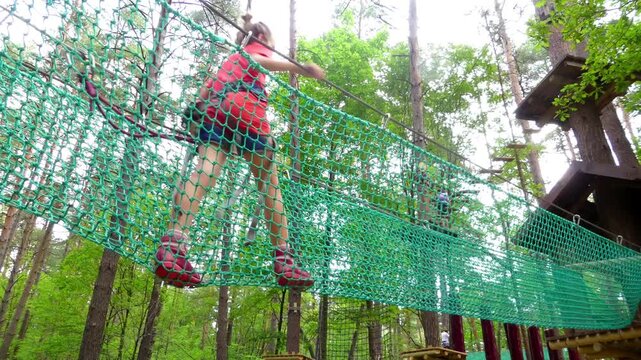 Small girl with helmet in adventure park