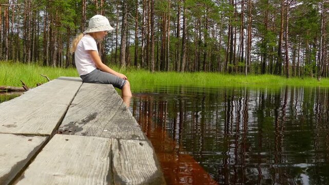 Little girl walks on Swamp Viru Raba in Estonia