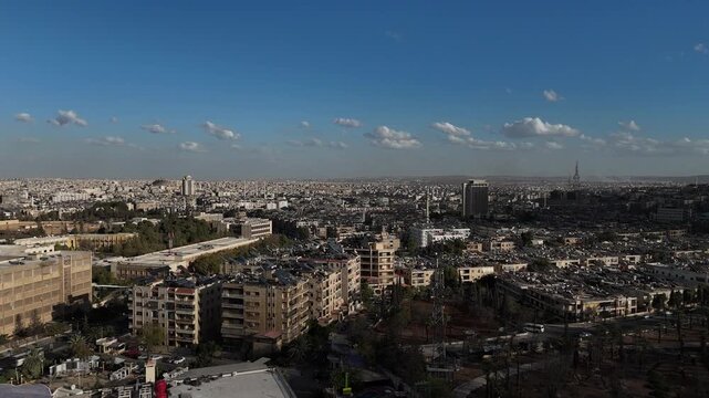 Drone view of a city landscape in Aleppo, Syria. Urban skyline and residential neighborhoods from above. City streets, infrastructure, and middle eastern architecture.