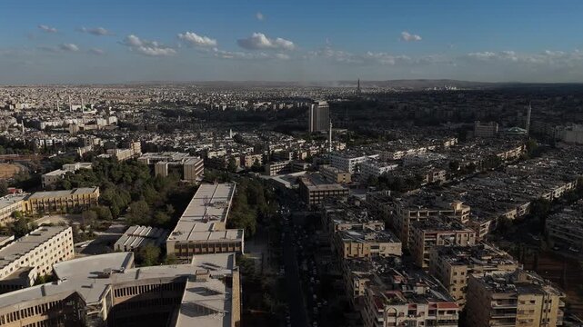 Drone view of a city landscape in Aleppo, Syria. Urban skyline and residential neighborhoods from above. City streets, infrastructure, and middle eastern architecture.