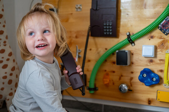 Toddler Exploring a Sensory Board with Real-Life Objects &ndash; Montessori-Inspired Learning, Fine Motor Skills and Child Development