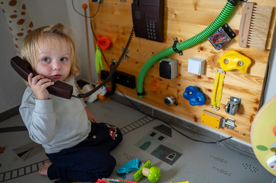 Toddler Exploring a Sensory Board with Real-Life Objects &ndash; Montessori-Inspired Learning, Fine Motor Skills and Child Development