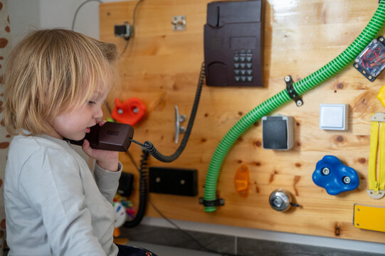 Toddler Exploring a Sensory Board with Real-Life Objects &ndash; Montessori-Inspired Learning, Fine Motor Skills and Child Development