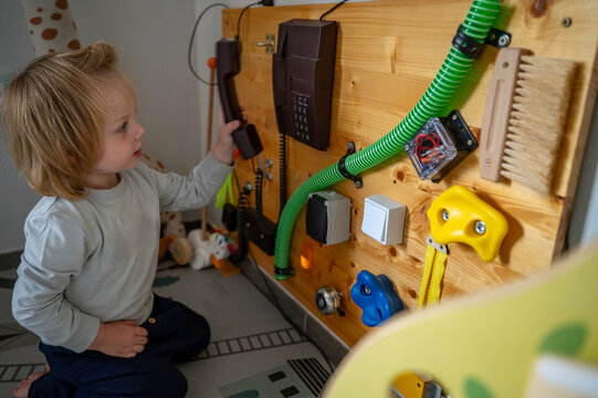Toddler Exploring a Sensory Board with Real-Life Objects &ndash; Montessori-Inspired Learning, Fine Motor Skills and Child Development