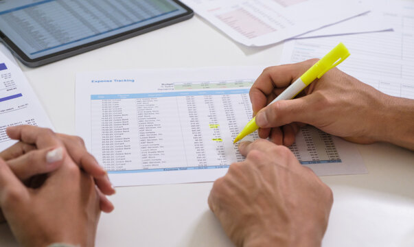 Couple budgeting and calculating tax with laptop at home, managing finance and planning for longterm investment