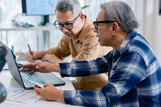 Senior male participating in a computer programming bootcamp, improving skills and learning coding and develope collaborating in brainstorming and coding project