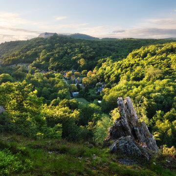 Castle of Cerveny Kamen in Slovakia at sunset with green forest