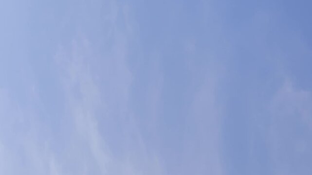 Passenger airplane approaching for landing against a blue sky, captured in flight with the aircraft descending toward the runway.
