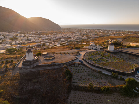 Drone aerial perspective of traditional Greek windmills on Gavrilos Hill above Emporio Santorini