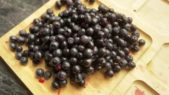 Fresh ripe raspberries spread across a wooden serving tray, healthy summer fruit, berry harvest, natural snack, seasonal food background.