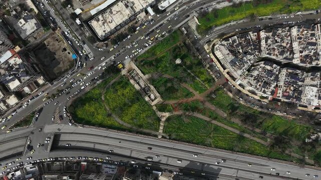 Drone view of a city landscape in Aleppo, Syria. Urban skyline and residential neighborhoods from above. City streets, infrastructure, and middle eastern architecture.