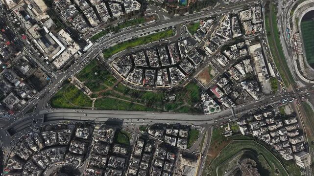 Drone view of a city landscape in Aleppo, Syria. Urban skyline and residential neighborhoods from above. City streets, infrastructure, and middle eastern architecture.