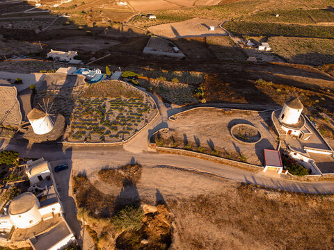 Top down drone aerial view of historic whitewashed windmills and vineyards on Gavrilos Hill in Emporio Santorini