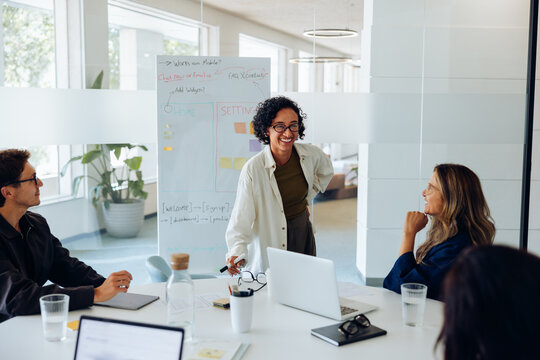 Female ux designer presents to team during meeting