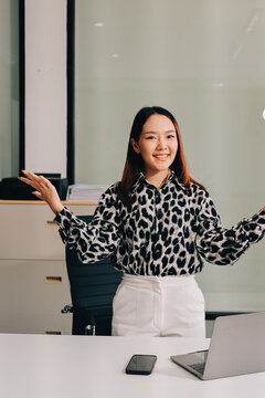 Confident asian business woman standing in modern office