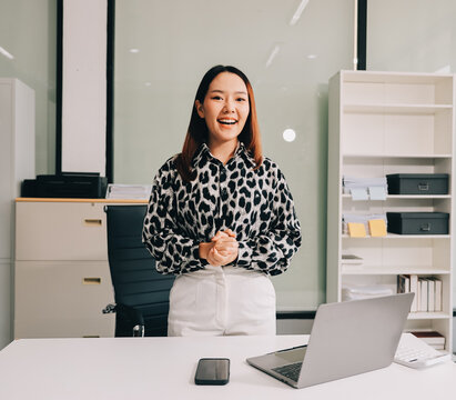 Confident asian business woman standing in modern office