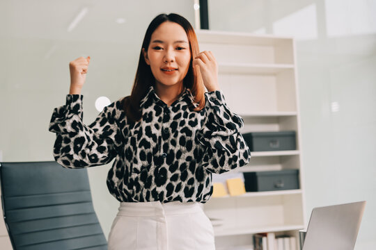 Confident asian business woman standing in modern office