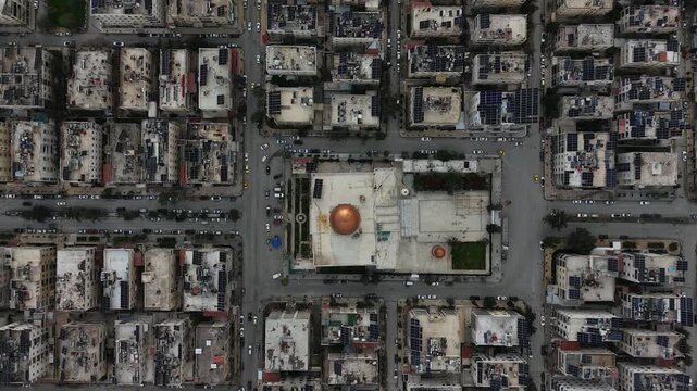 Drone view of a city landscape in Aleppo, Syria. Urban skyline and residential neighborhoods from above. City streets, infrastructure, and middle eastern architecture.