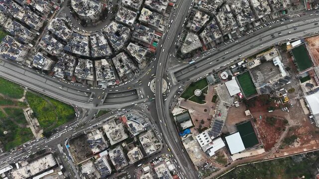Drone view of a city landscape in Aleppo, Syria. Urban skyline and residential neighborhoods from above. City streets, infrastructure, and middle eastern architecture.