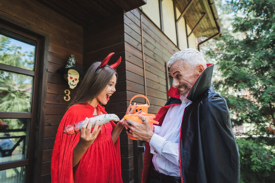 Mother and child delight in Halloween festivities in cozy autumn setting