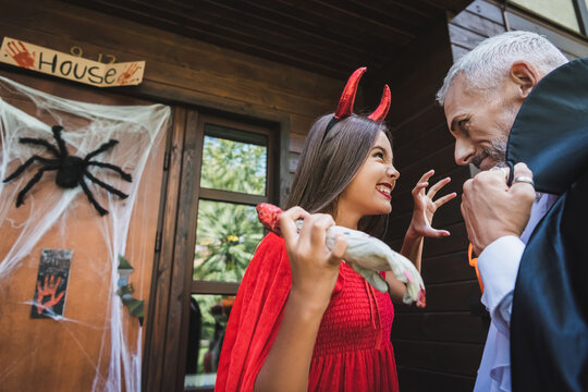 Mother and child celebrate Halloween with joy and costumes outdoors