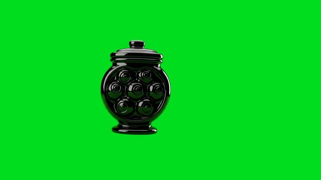 A shiny black ceramic jar with a decorative pattern on a green background