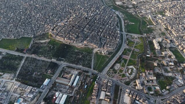 Drone view of a city landscape in Aleppo, Syria. Urban skyline and residential neighborhoods from above. City streets, infrastructure, and middle eastern architecture.