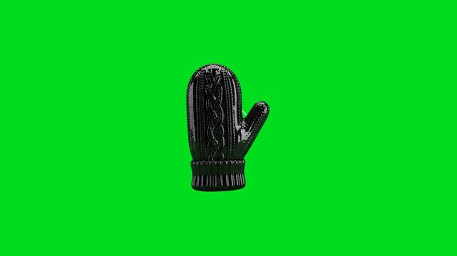 A single glossy black knitted winter mitten isolated on a bright green background
