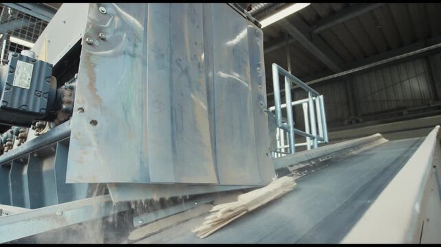 Wooden batten drops from a conveyor chute in a sawmill