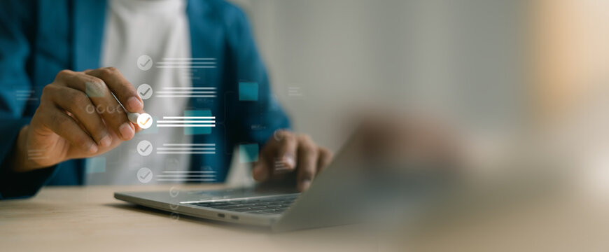 Businessman reviewing digital documents and answering questionnaire with stylus pen.