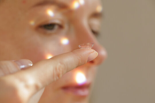 Woman Holding Contact Lens on Finger Before Eye Insertion