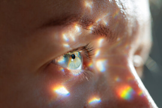 Human eye close up with prism light reflections and sharp iris detail