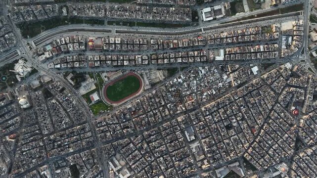 Drone view of a city landscape in Aleppo, Syria. Urban skyline and residential neighborhoods from above. City streets, infrastructure, and middle eastern architecture.