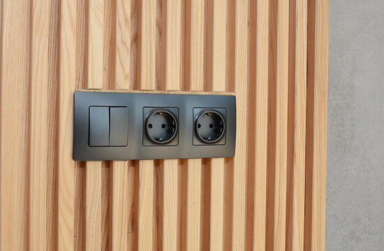 Electrical outlet light switch on wooden wall