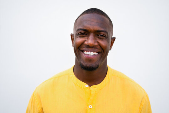 African american man, businessman face close headshot, big smiling expression in casual isolated studio business portrait for professional use. Happy young executive closeup profile picture with