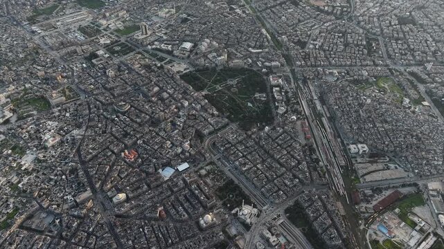 Drone view of a city landscape in Aleppo, Syria. Urban skyline and residential neighborhoods from above. City streets, infrastructure, and middle eastern architecture.