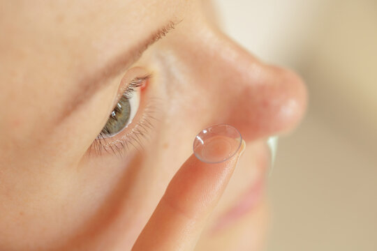 Contact lens application closeup showing vision correction instead of glasses