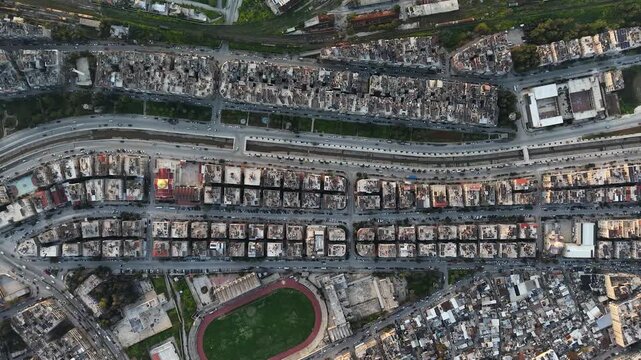 Drone view of a city landscape in Aleppo, Syria. Urban skyline and residential neighborhoods from above. City streets, infrastructure, and middle eastern architecture.