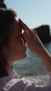 Sunscreen cream application young woman applies white sunblock on nose and face at sunny beach for skin protection
