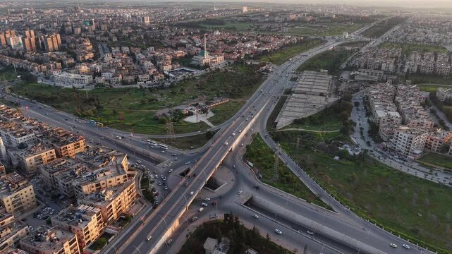 Drone view of a city landscape in Aleppo, Syria. Urban skyline and residential neighborhoods from above. City streets, infrastructure, and middle eastern architecture.