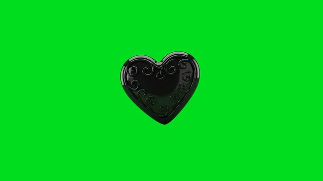 A shiny black heart icon featuring intricate swirl patterns on green screen