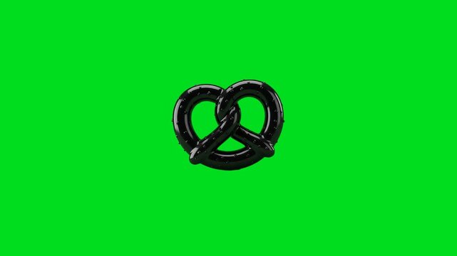 A shiny black pretzel isolated against a vibrant green screen background