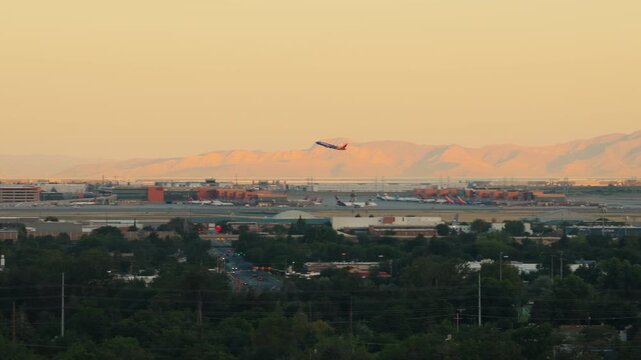 Airplane Takeoff at Salt Lake City International Airport Utah Sunrise Panning Left
