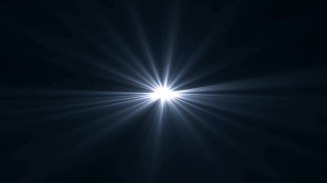 Bright central light emitting radial beams across dark background with no motion