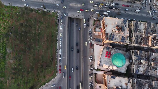 Drone view of a city landscape in Aleppo, Syria. Urban skyline and residential neighborhoods from above. City streets, infrastructure, and middle eastern architecture.