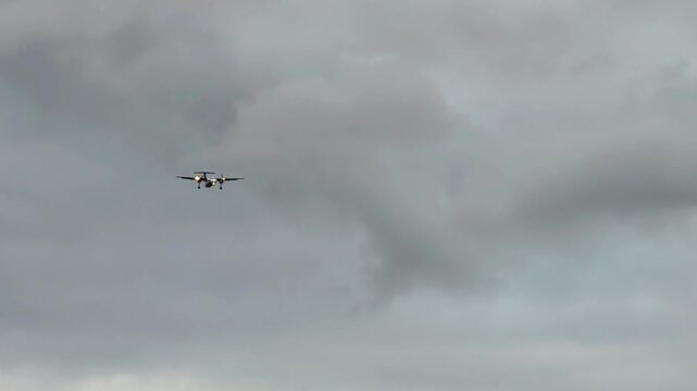 Passenger airplane landing through cloudy sky, descending gradually with visible propellers and landing gear, showcasing aerial technology in a natural environment

149 / 200
