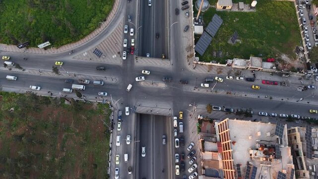 Drone view of a city landscape in Aleppo, Syria. Urban skyline and residential neighborhoods from above. City streets, infrastructure, and middle eastern architecture.