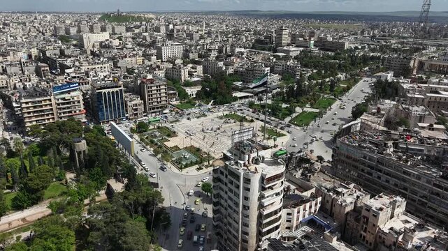 Drone view of a city landscape in Aleppo, Syria. Urban skyline and residential neighborhoods from above. City streets, infrastructure, and middle eastern architecture.